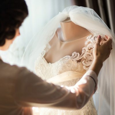 morning-of-the-bride-when-she-wears-a-beautiful-dress-woman-getting-picture-id990869854
